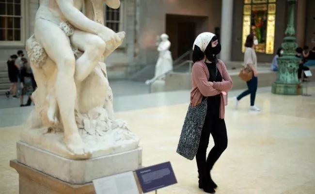 Besucherin im Metropolitan Museum of Art in New York City am Öffnungstag trägt Mund-Nasen-Schutz