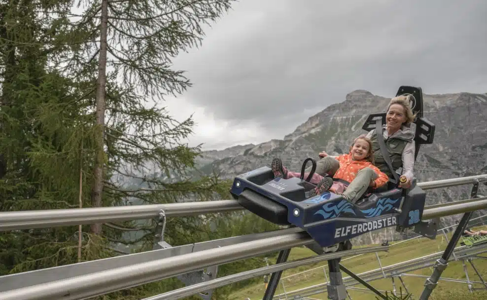 Eine Frau und ein Kind fahren mit dem Elfercoaster am Elfer in Neustift im Stubaital.