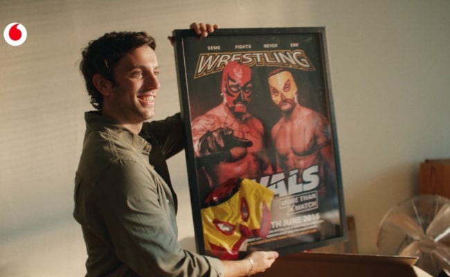 Mann mit gerahmtem Wrestling-Poster im Vodafone-Spot „Couple Love“ von McCann Wien.