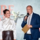Elisabeth Laimighofer und Richard Grasl auf der Werbe-Amor-Bühne; Grasl spricht ins Mikrofon.